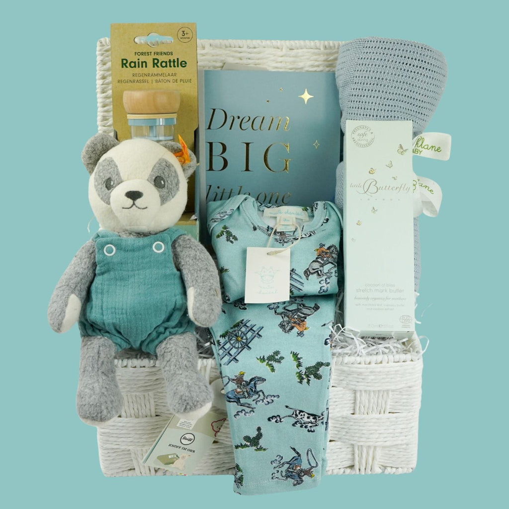 luxury baby boy gift hamper with blue rain rattle, dream big photo album in blue . blue bamboo cellular blanket, luxury GOTs panda soft toy by Steiff, Luxury baby boy pyjamas with cowboys, mum stretch mark cream