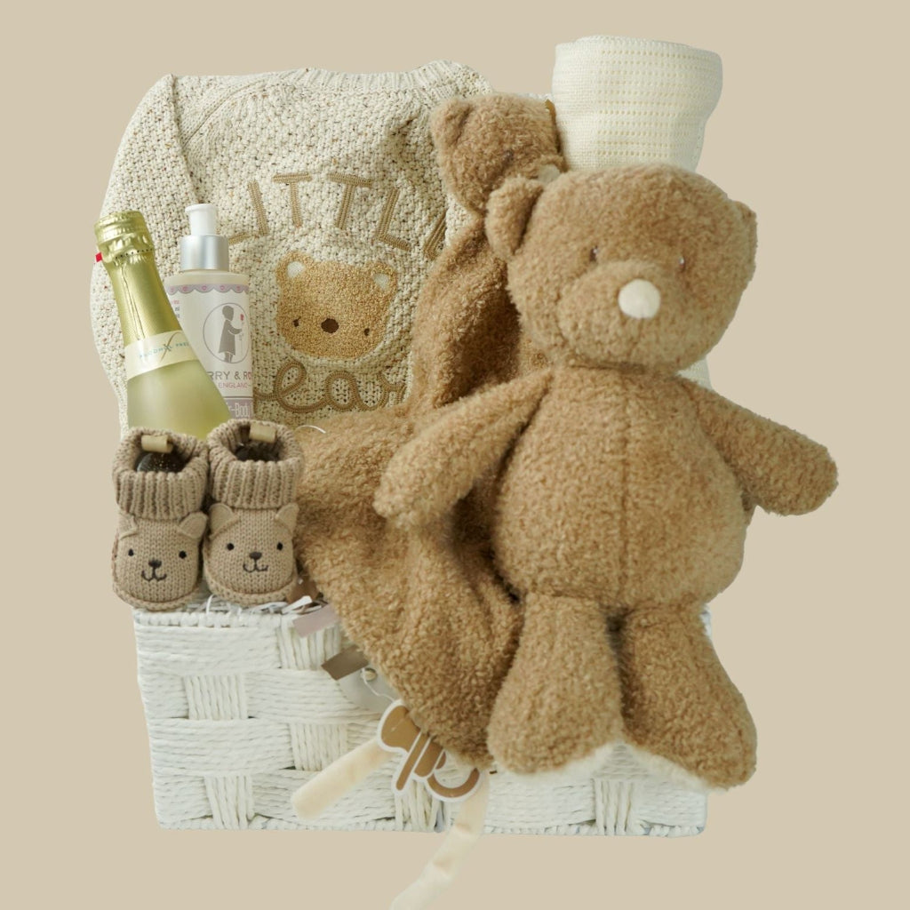 teddy themed baby gift hamper, neutral cream baby cardigan with embroidered teddy on the back, soft Nattou teddy with matching comforter, caramel coloured baby teddy booties, baby organic wash, no alcohol prosecco