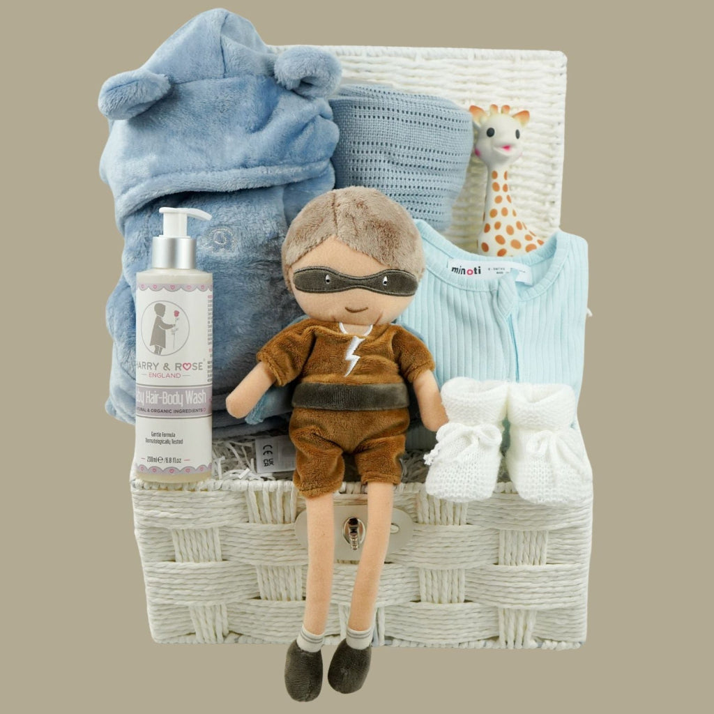 aby gift basket with plush toy, clothing, and baby products including sleepsuit, toiletries, Sophie la giraffe, botties , baby dressing gown in dusty blue