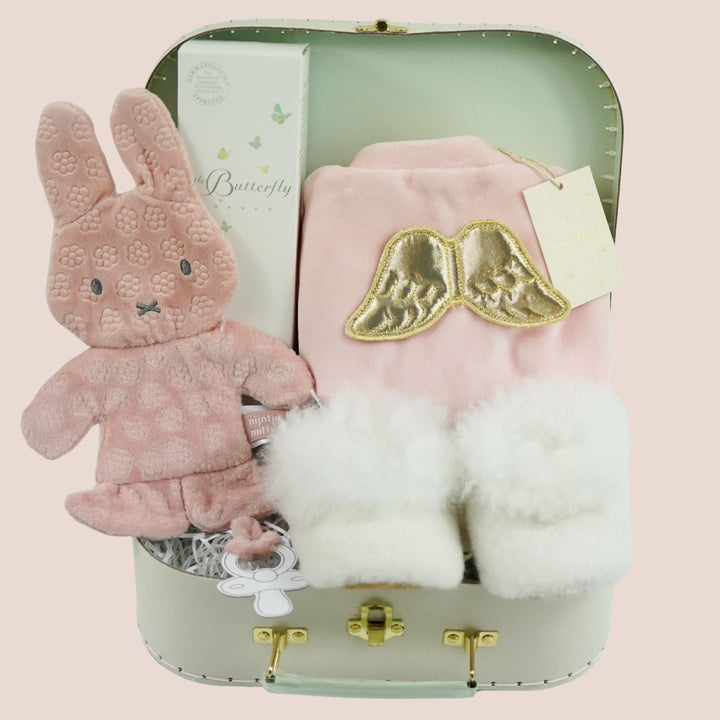 luxury baby girl gift, pink velour sleepsuit with gold angel wings by Marie-Chantal, alpaca white baby slippers, Organic baby toiletries  and pink miffy comforter 