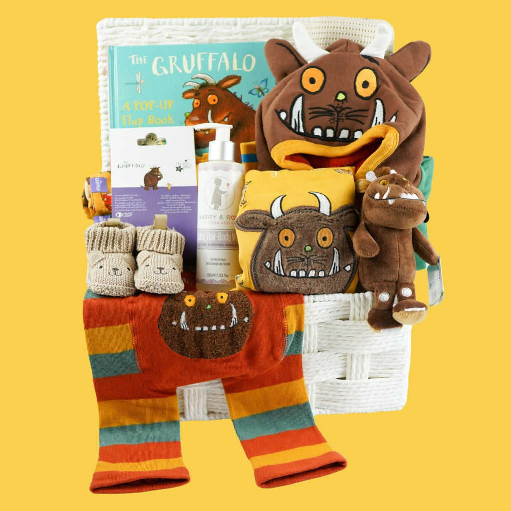 Hamper  of 'The Gruffalo' themed baby items including a plush toy, baby clothing set, book, and baby booties, baby toiletries