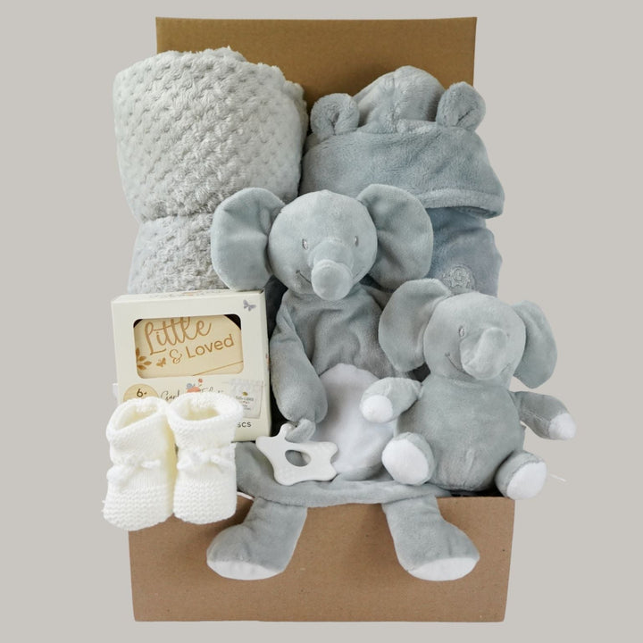 grey elephant hamper with blanket baby comforter, baby dressing gown and soft elephant toy , wooden milestone discs and white booties 