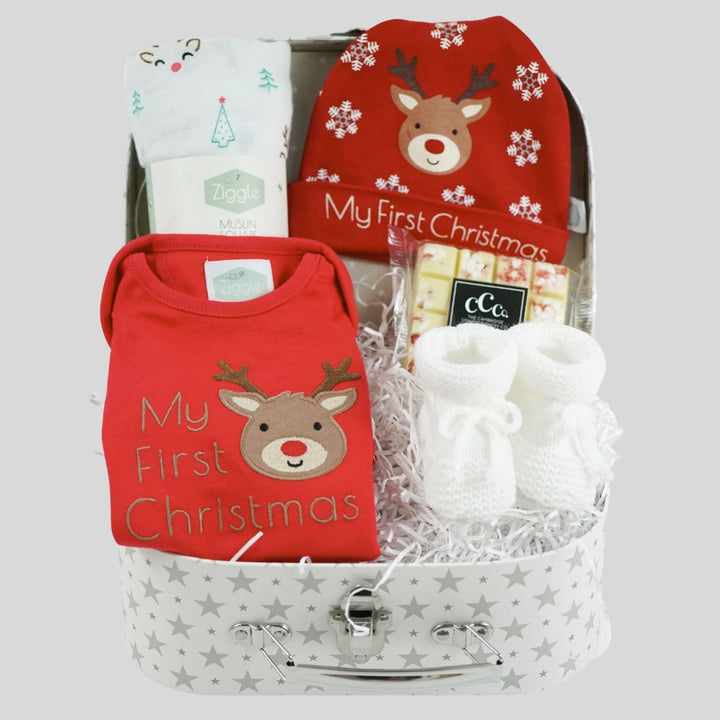 Baby gift set with red 'My First Christmas' shirt, socks, and booties in a decorative box.