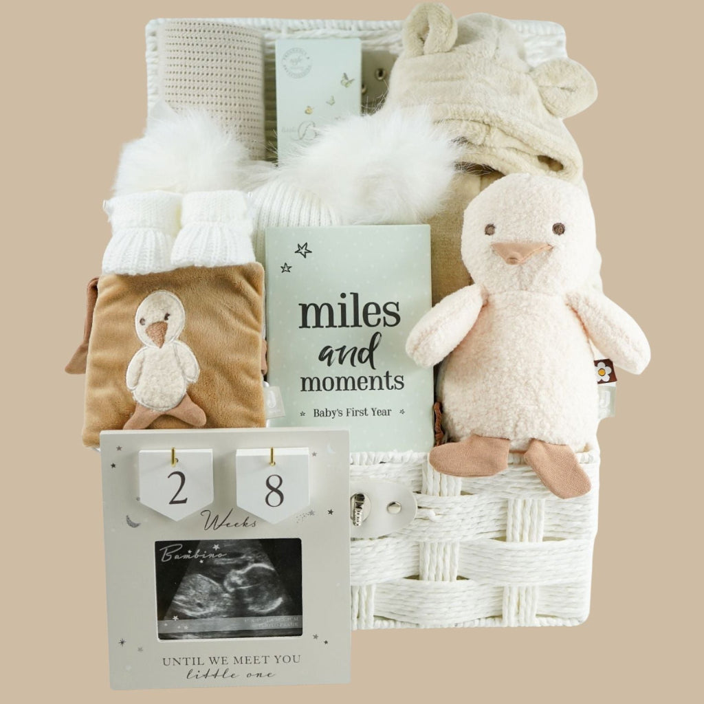 neutral pregnancy hamper basket with countdown scan frame, baby dressing gown and duck book and soft toy