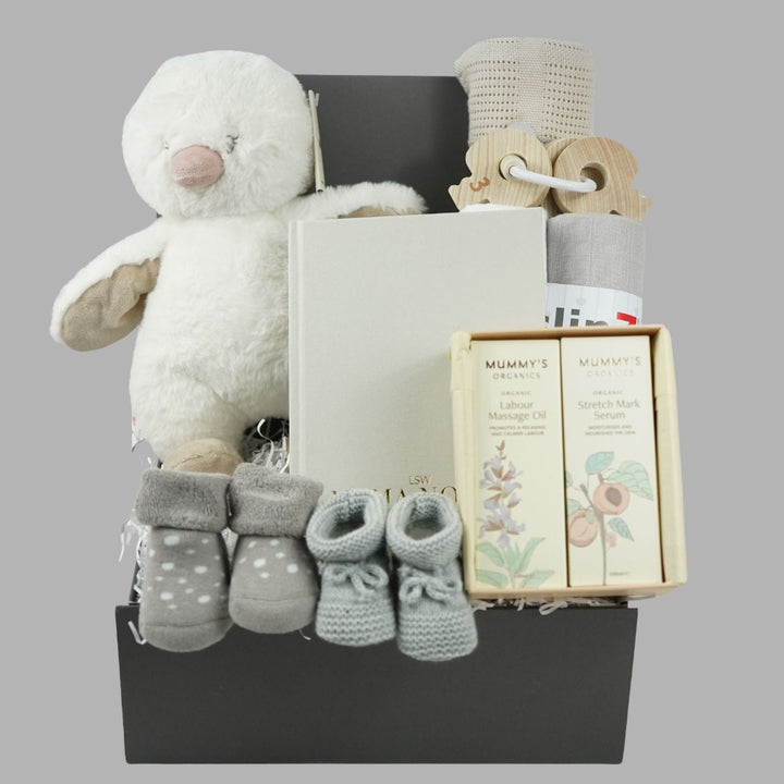 Pregnancy gift hamper with soft white due, pregnancy journal, pregnancy and labour toiletries, baby cellular blanket, wooden keys, booties and socks 