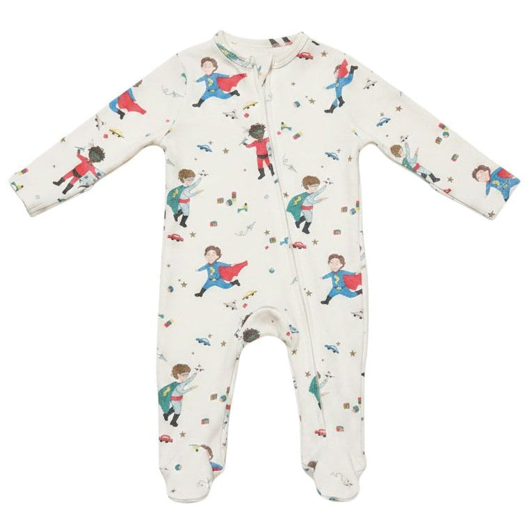 A long-sleeve footed baby sleeper in off-white, featuring an all-over print of children dressed as superheroes with red and blue costumes.