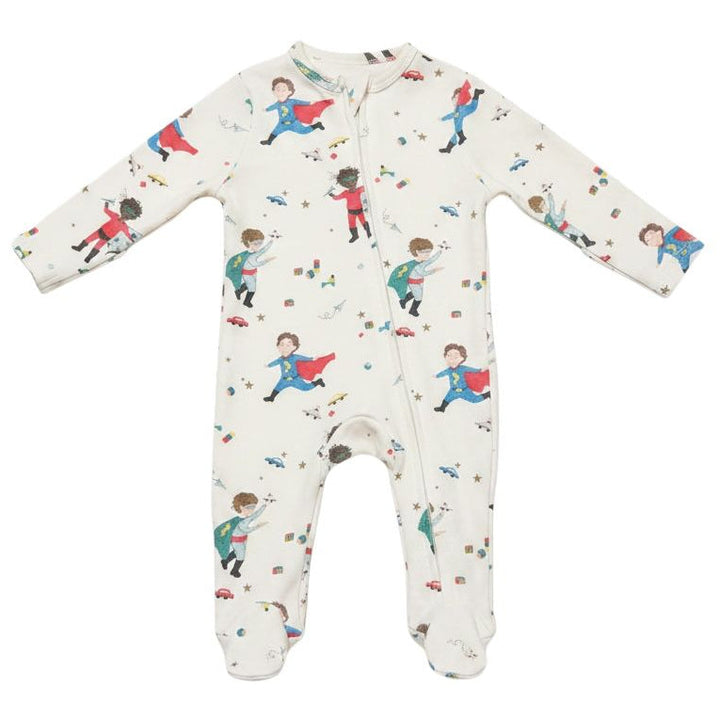 A long-sleeve footed baby sleeper in off-white, featuring an all-over print of children dressed as superheroes with red and blue costumes.