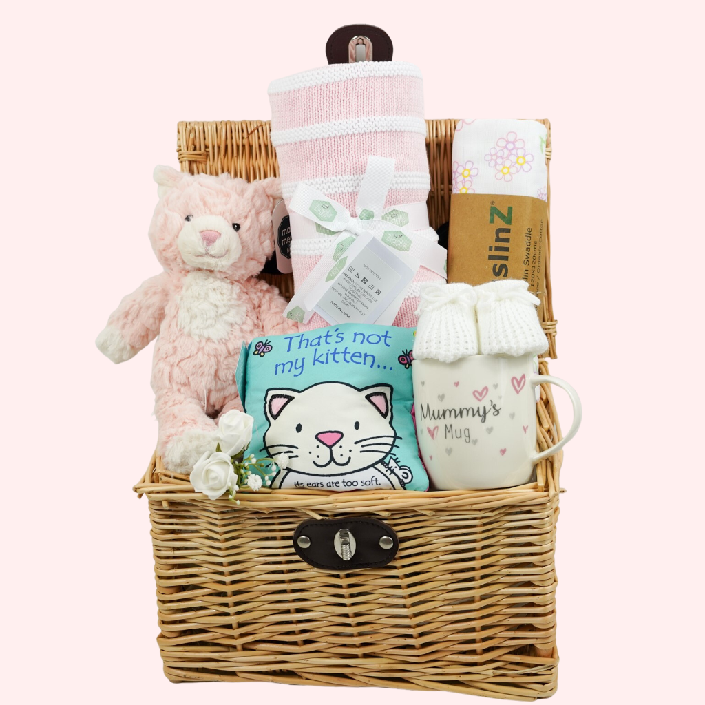 Baby girl hamper basket, pink kitty soft toy, pink and white striped baby blanket, Thats not my kitty baby soft book, new mummy mug, white knit baby bootees , muslin swaddle in white with pink flowers 