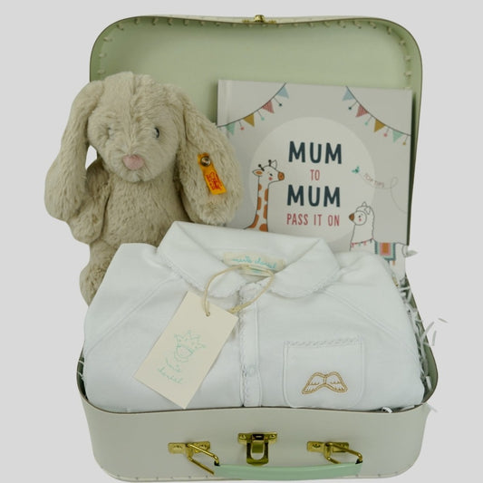 Gift suitcase with white angel wings baby sleepsuit in white with gold angel wings embroidered on the fron pocket, mum to mum advice book, soft grey hoppie rabbit with steiff button in the ear