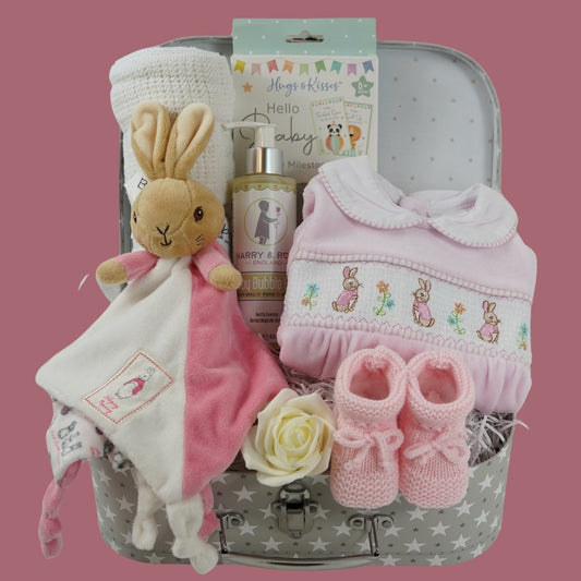Baby girl  hamper with flopsy bunny comforter in pink and white, baby cellular blanket, baby milestone cards , cute pink velour baby sleepsuit with smocked front with flopsy bunny, pink knit booties , baby organic wash