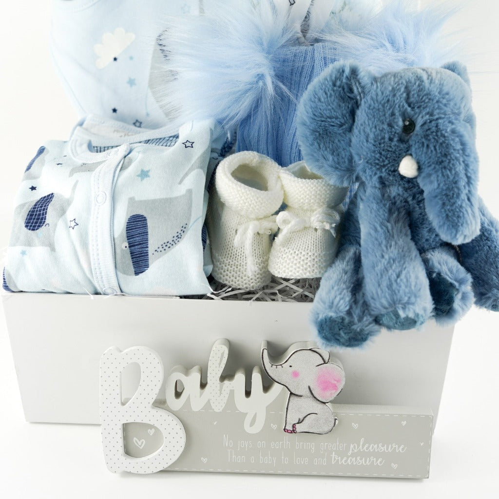 baby boy blue clothing set with grey elephants, blue eco friendly soft elephant, blue knit double fluffy pom pom baby hat, baby nursery sign with an elephant, white knot booties , blue baby blanket with grey elephants