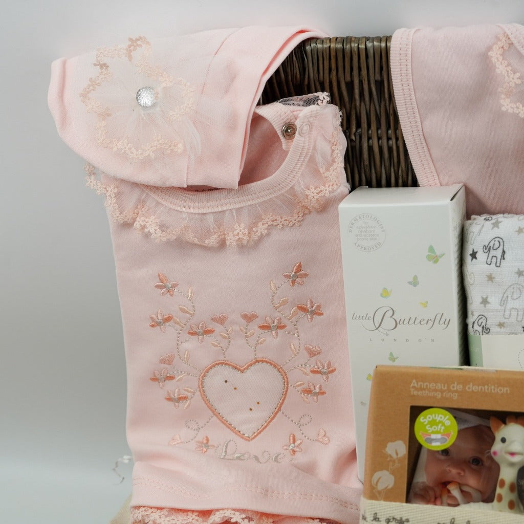 baby girl gift basket, peach spanish clothing set, sophie la giraffe teether, Little Butterfly London baby toiletries, rag doll toy, white muslin with grey elephants , white knit booties