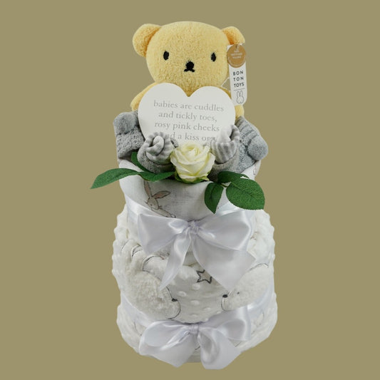 baby nappy cake, yellow boris bear, baby striped grey socks, baby knit bootees in grey with pom poms, baby dimple blanket in white with sherpa backing and teddy and rabbit applique , baby plaque 