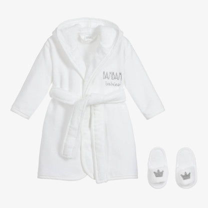 boxed white fluffy cotton baby dressing gown with Bam Bam embroidered, white slip on baby slippers with a crown embroidered