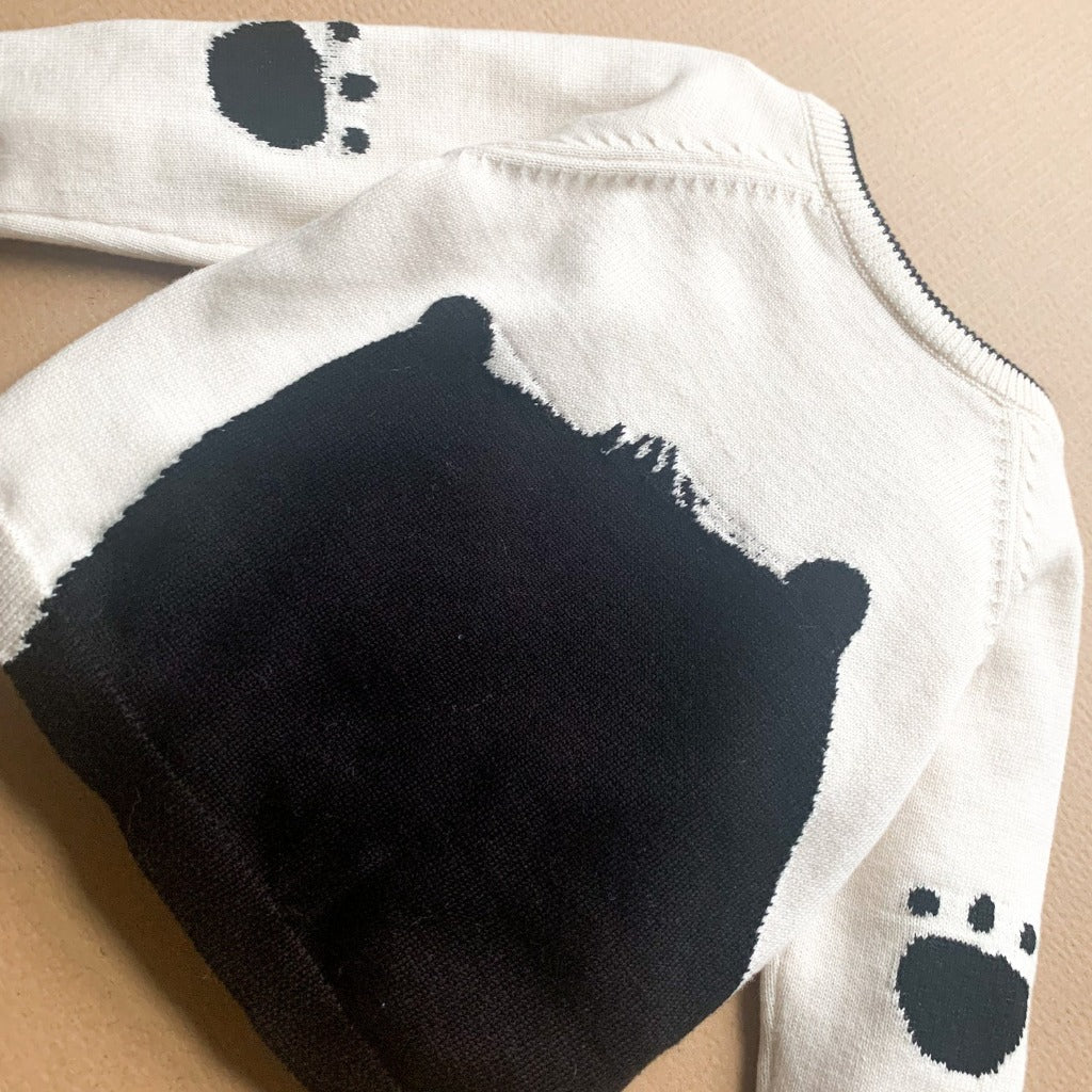 Cream and black baby jumper with bear face on the front and back and paw prints on the back of the arms