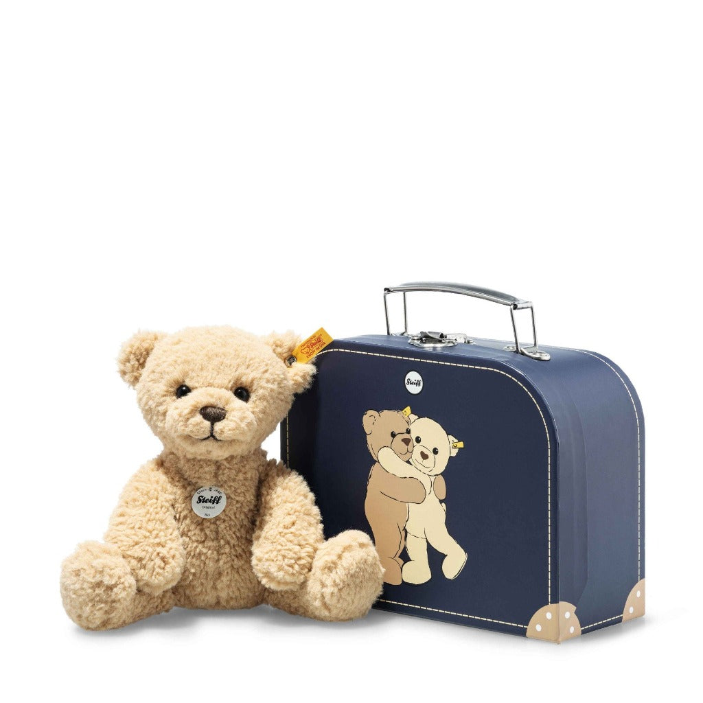 Soft beige baby steiff  teddy bear in a navy suitcase 