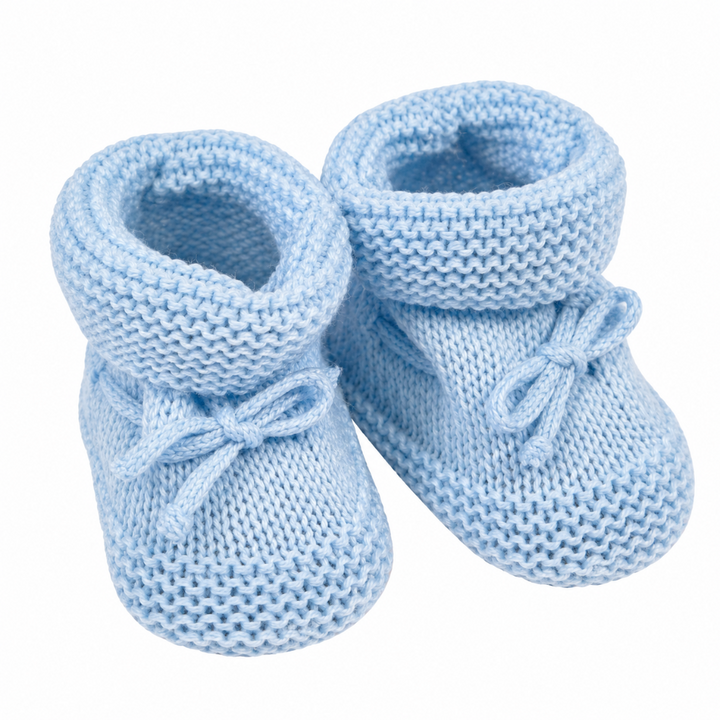 A pair of light blue knitted baby booties with soft bow details on the front, shown against a plain white background.