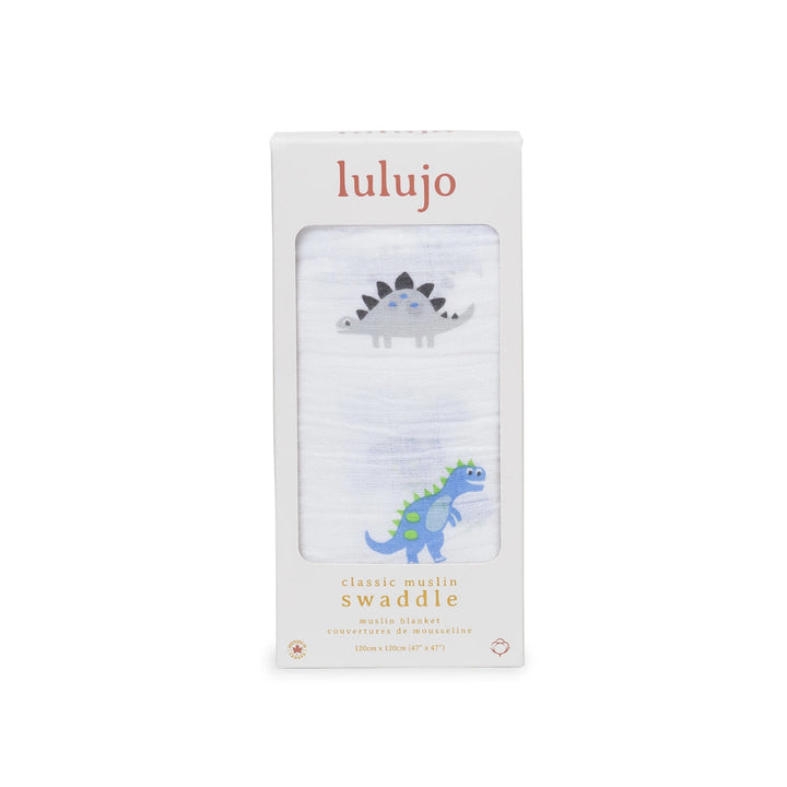 Lulujo Classic Muslin Swaddle in white packaging, featuring a window that displays a white muslin blanket with a gray stegosaurus and a blue-green dinosaur illustration.