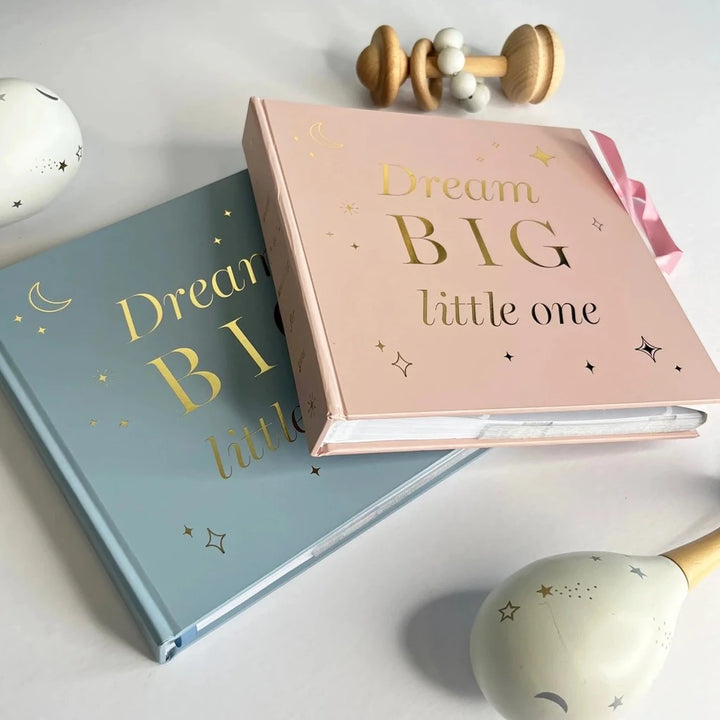 Pink baby photo album with gold lettering on the front and pink ribbon tie