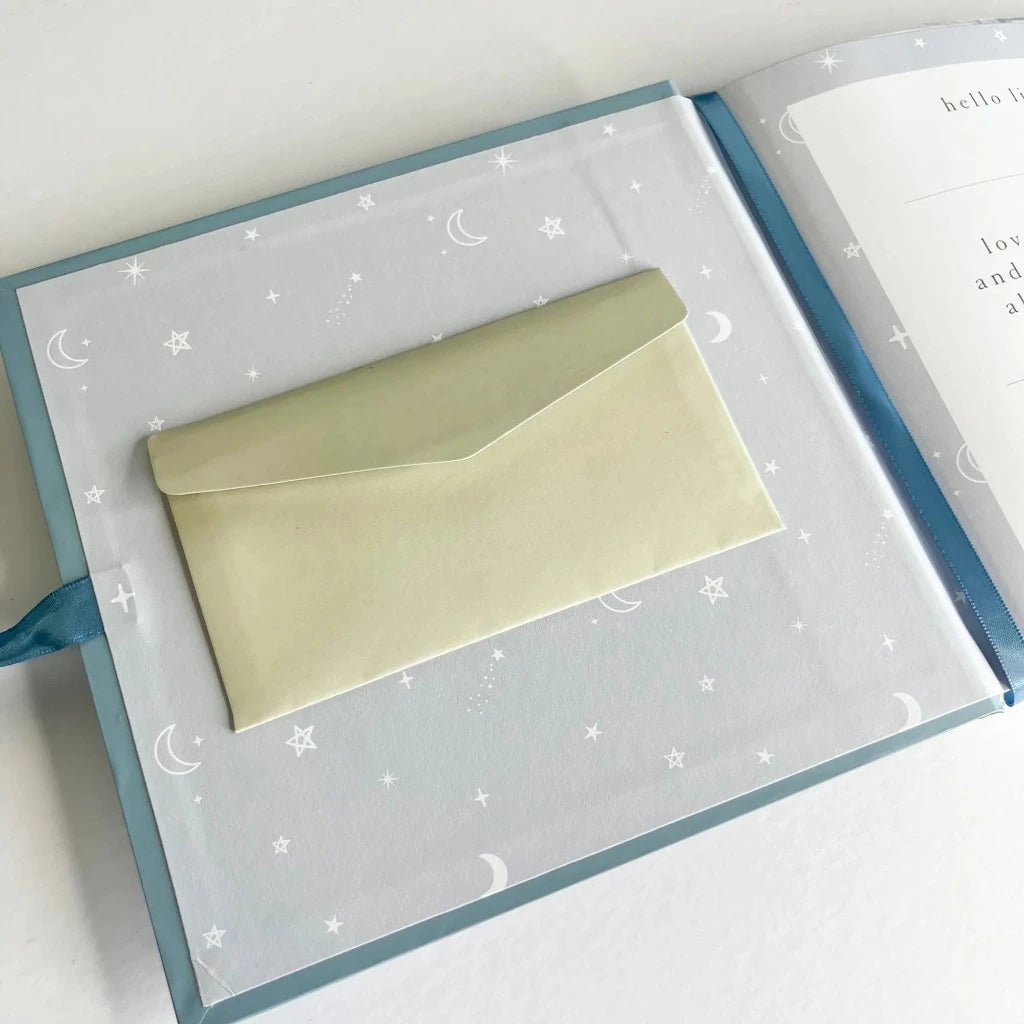 Dream big photo album for a baby, blue cover with gold writing and blue ribbon tie