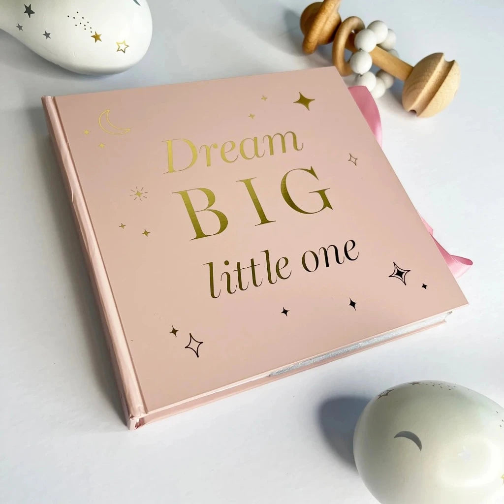 Pink baby photo album with gold lettering on the front and pink ribbon tie 