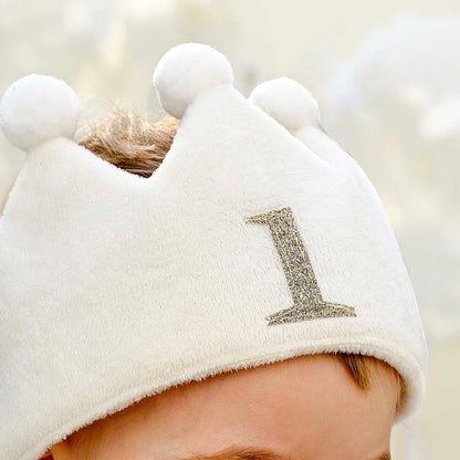 white fabric first birthday crown with white pom poms