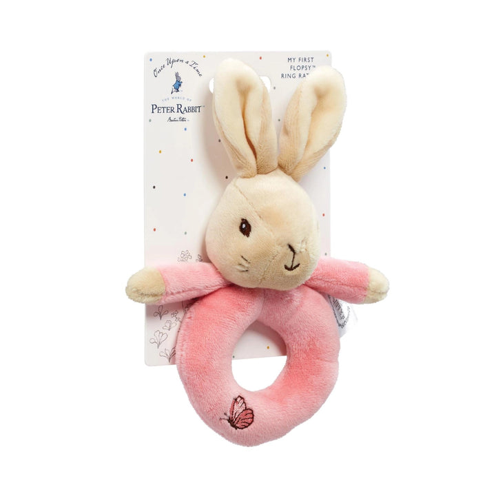 Plush bunny rattle toy with pink ring on a Peter Rabbit branded card