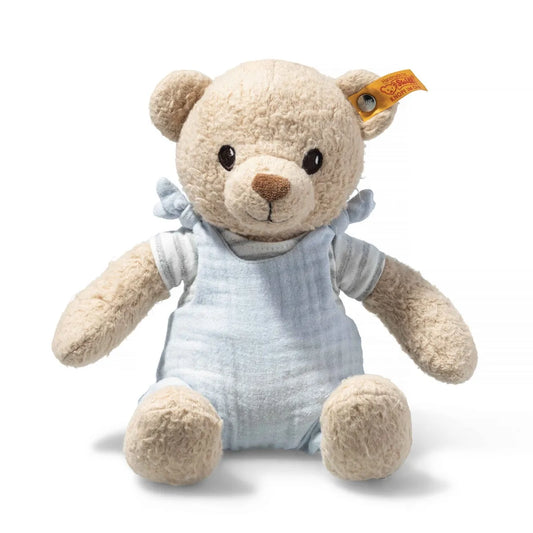 Steiff teddyy bear in organic materials, wearing pale blue dungarees
