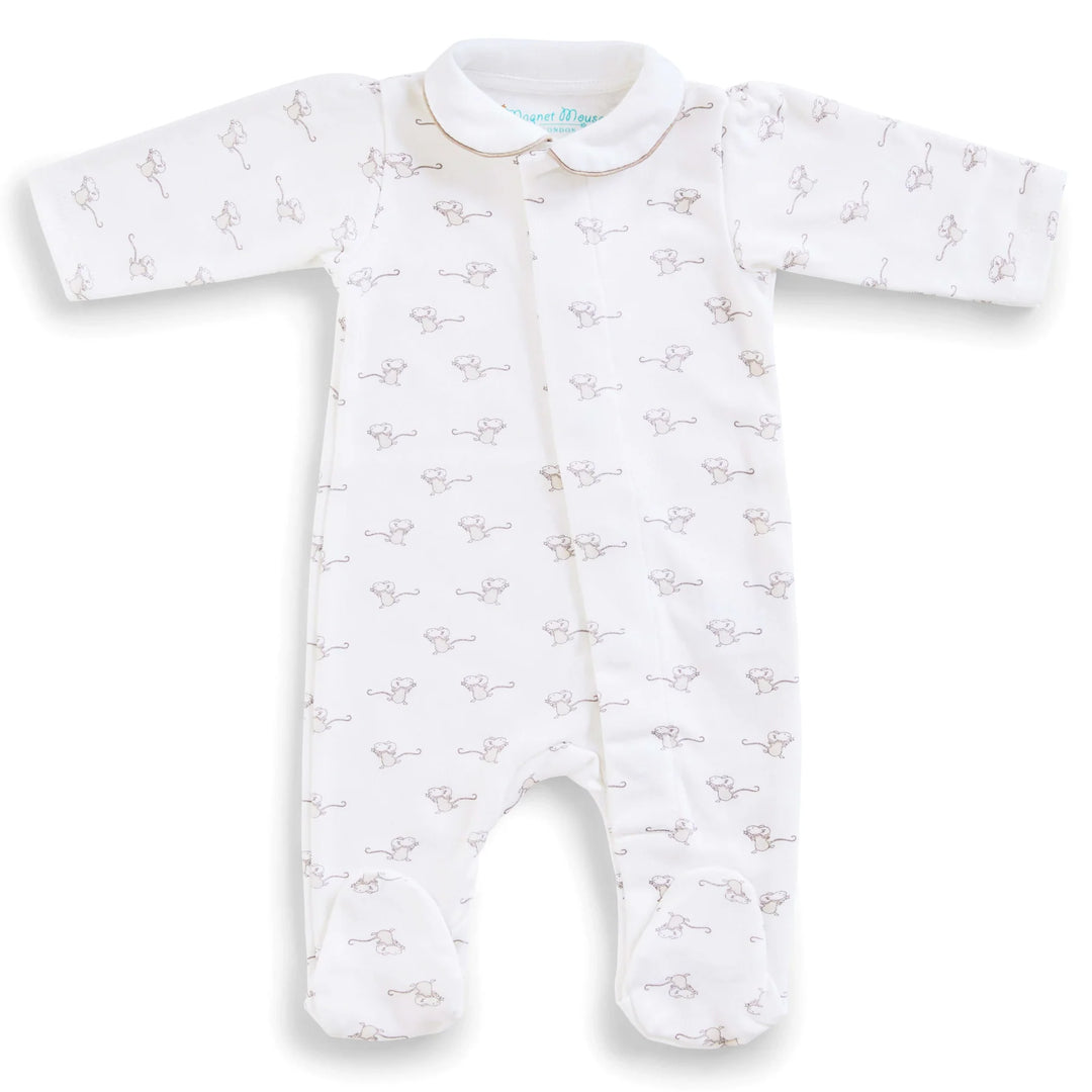 A white long-sleeve baby footed sleeper with an all-over light brown guitar print, featuring a Peter Pan collar and front zipper.