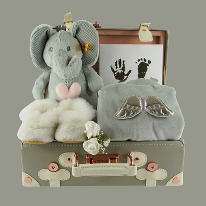 Grey baby suitcase with Steiff grey musical elephant, white alpaca wool baby slippers , grey with silver angel wings baby velour sleepsuit, baby handprint set 