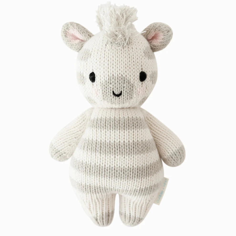 Knitted toy zebra on a white background
