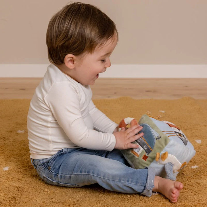 pale blue soft sailor themed activity cube, different activities on each side including a ring, knotty string, mirror