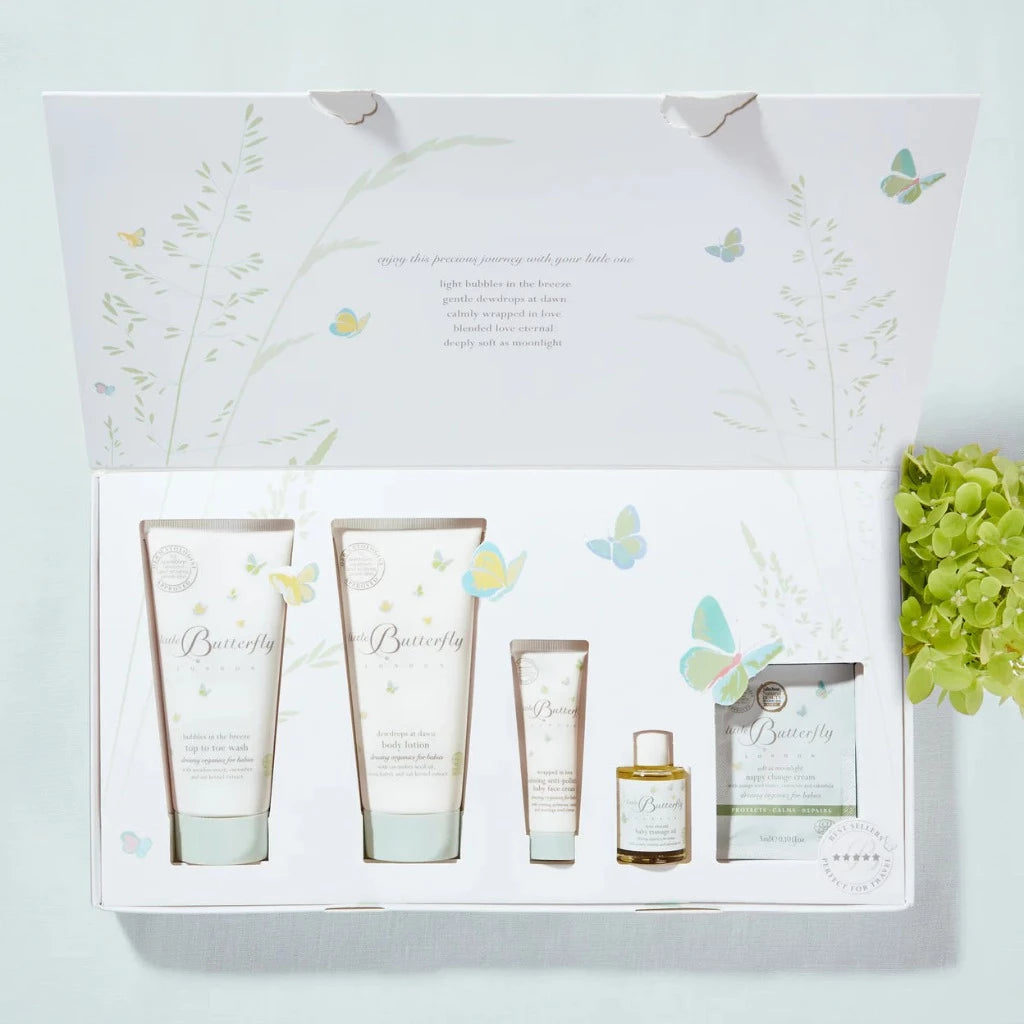 Baby toiletries in a white gift box with pastel butterflies