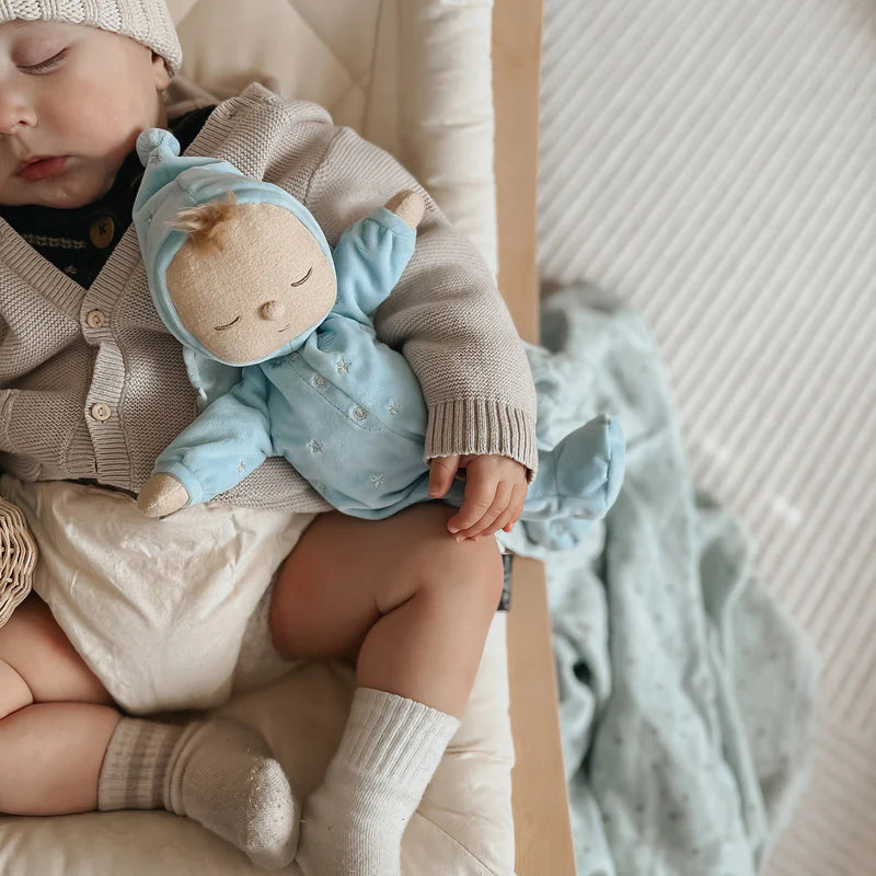 soft bodied doll in blue sleepsuit with musical pull string 