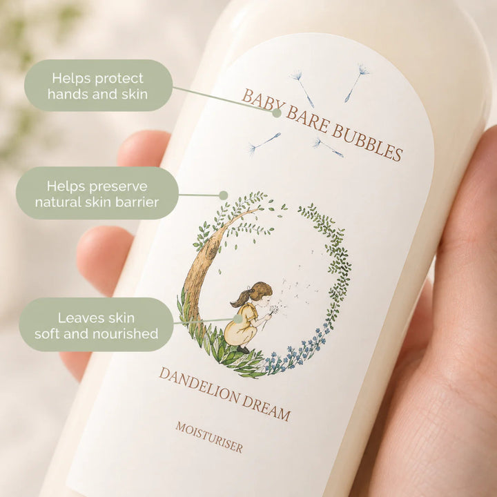 A hand holding a bottle of Baby Bare Bubbles Dandelion Dream Moisturiser. The bottle is off-white with a white label featuring a dandelion illustration and three green text callouts on the left.