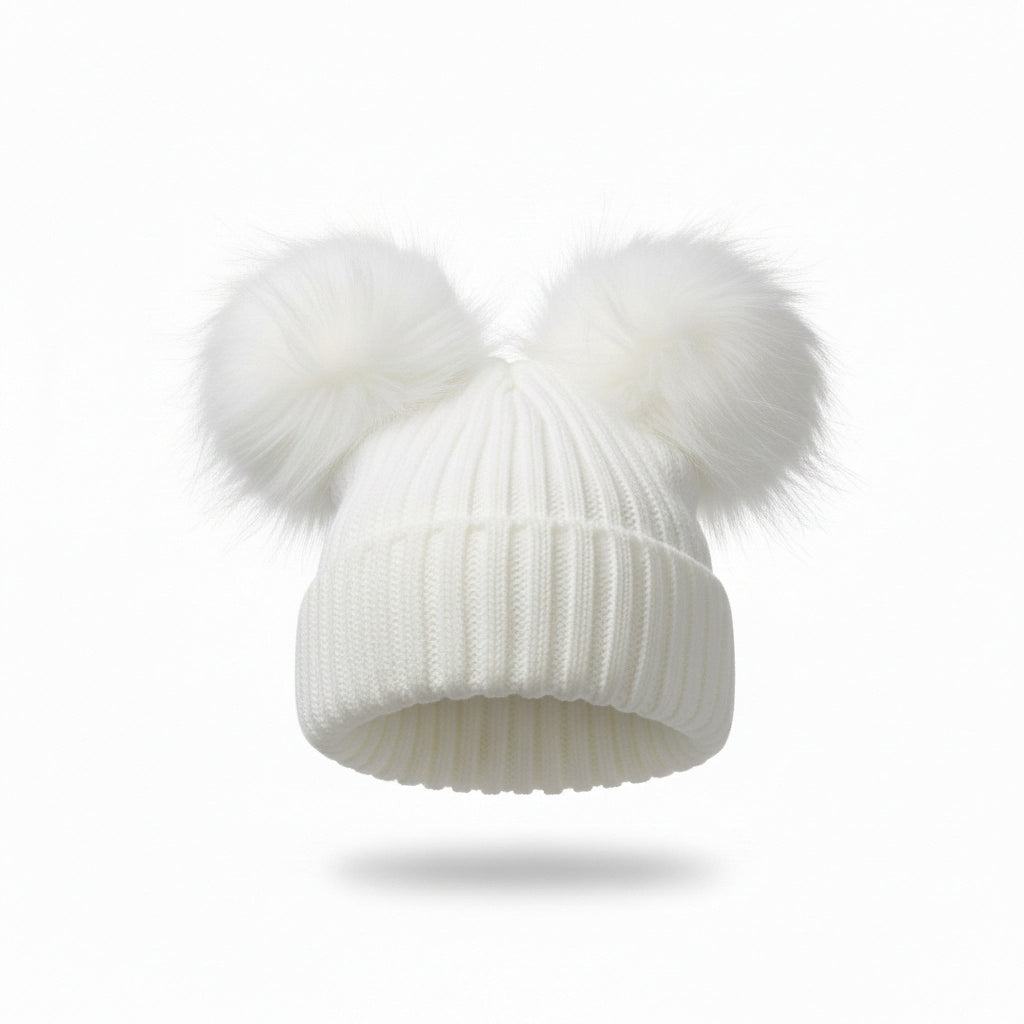 White knit beanie with two large white pom-poms on a light gray background