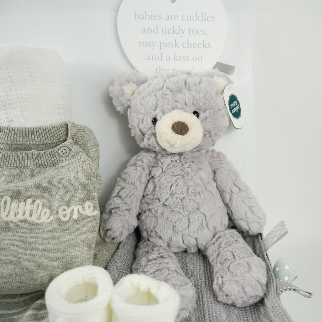 neutral baby hamper, grey and white fine knit baby 2 piece outfit, , white cellular knit blanket, grey teddy bear, white knit booties, grey knit taggie blanket, nursery plaque