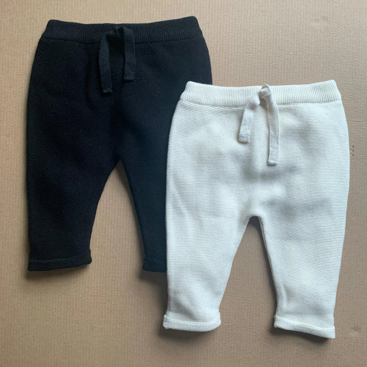 black baby joggers and cream baby joggers in organic cotton