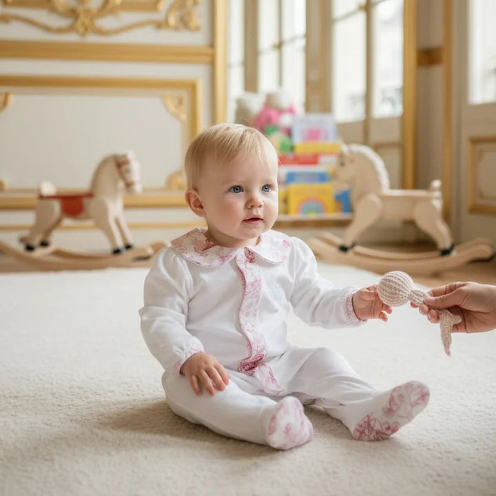 organic cotton white sleepsuit with loral trim and collar