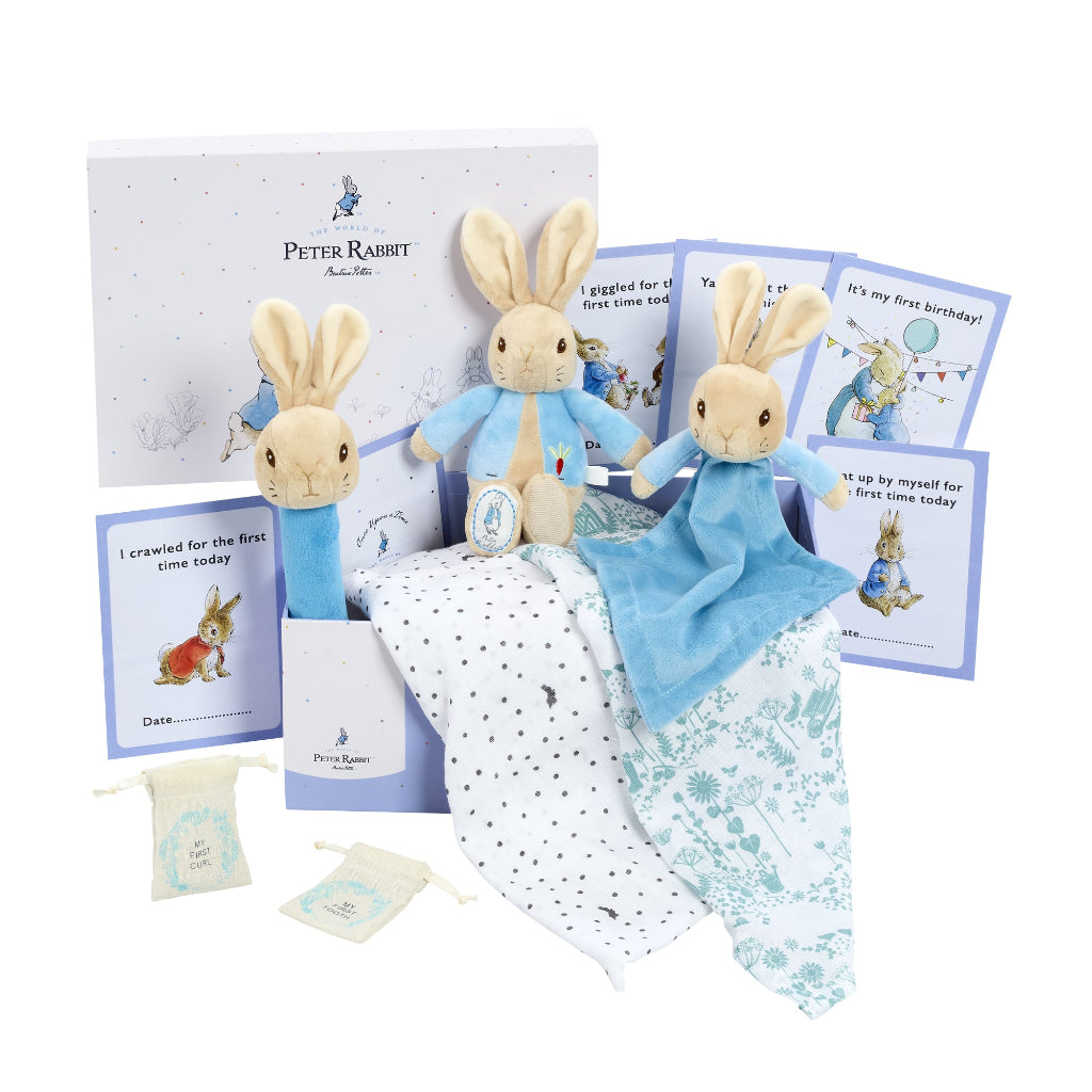 Peter rabbit gift keepsake box full of peter rabbit gifts including a blue peter rabbit comforter, soft toy and rattle, peter rabbit milestone cards 