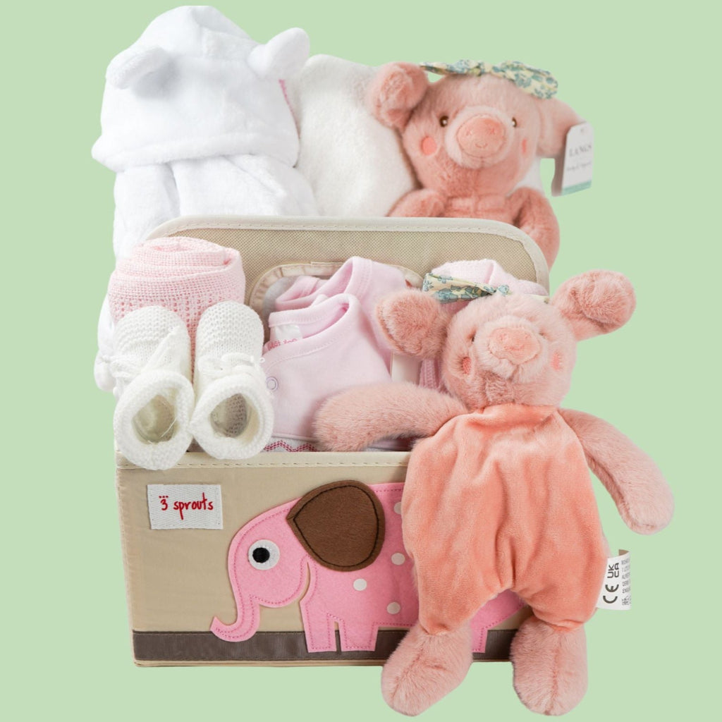 nappy caddy baby hamper gift with baby dressing gown white with cute ears, baby white hooded towel with pink/white edging, baby girl clothing set, pink pig soft toy with green headband and matching comforter, white baby booties, pink cellular blanket