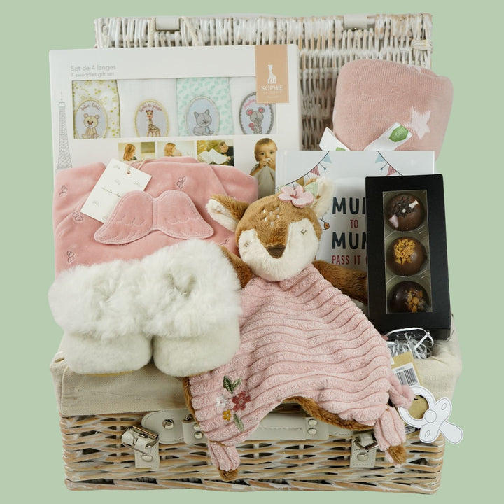 luxury mum and baby hamper, luxury pink velour sleepsuit with gold angel wings embroidery, pink star knit blanket, soft pink deer comforter,  ivory alpaca baby slippers, 4 sophie la giraffe muslins, box of chocolate domes, mum to mum tips book