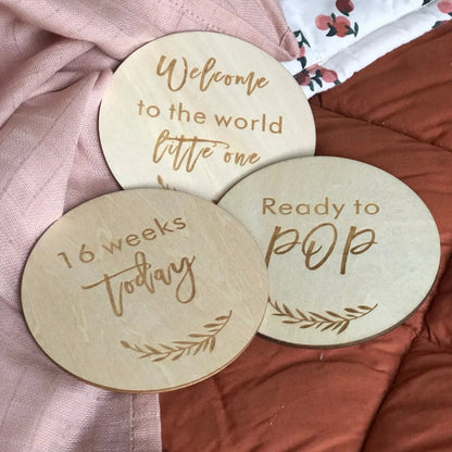 wooden pregnancy milestone discs in a natural drawstring bag