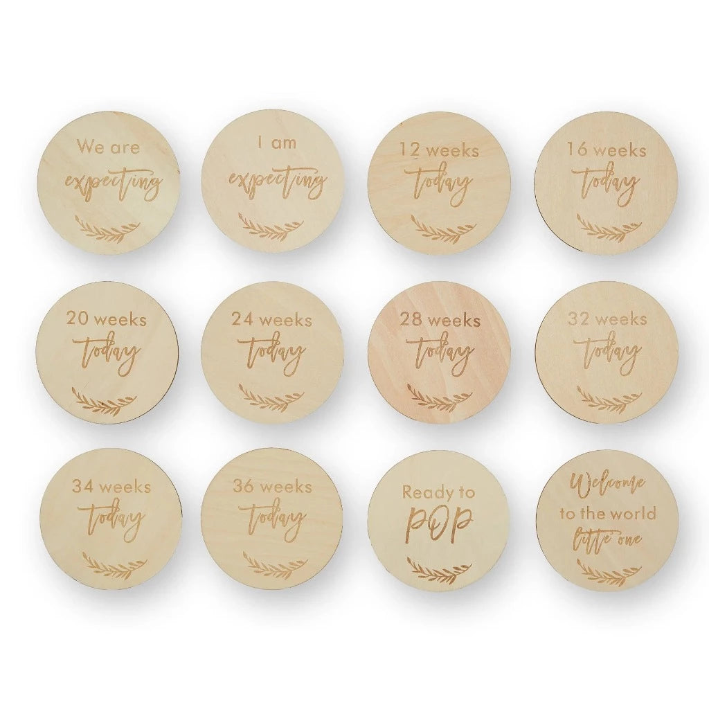 wooden pregnancy milestone discs in a natural drawstring bag