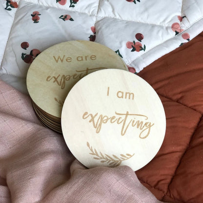 wooden pregnancy milestone discs in a natural drawstring bag