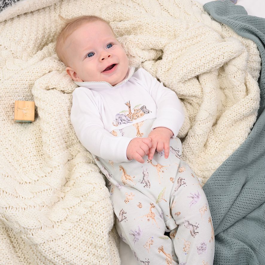 Baby sleepsuit in white and pale green with safari animals 