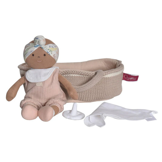 soft doll in a knitted cradle with a dummy and sheet
