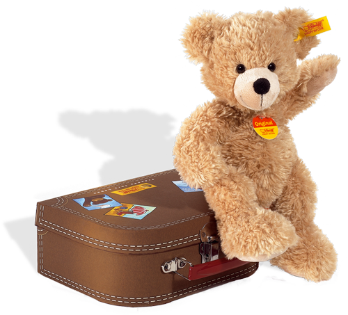 Beige teddy bear by steiff in a brown case, yellow tab button in ear