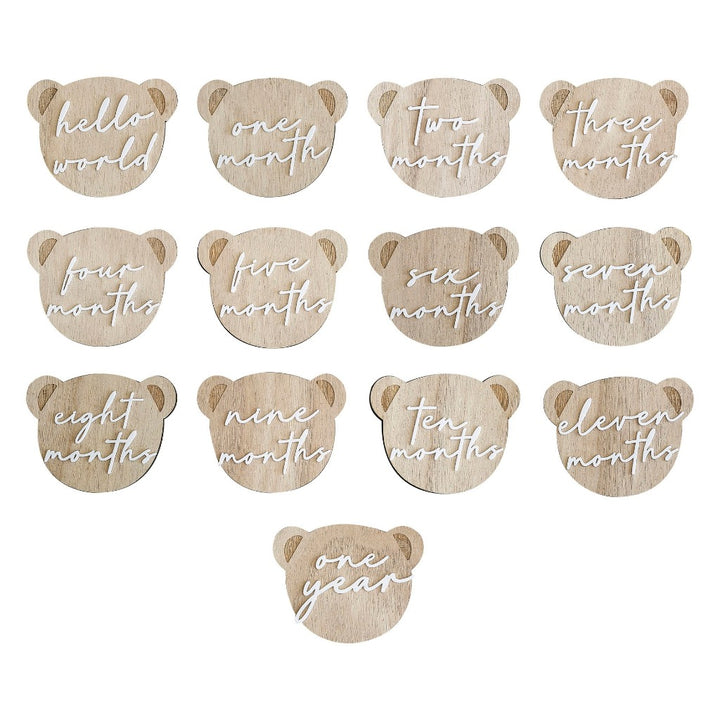 pregnancy milestone discs and baby milestone discs innthe shape of a teddy head on wood