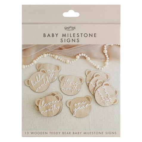 pregnancy milestone discs and baby milestone discs innthe shape of a teddy head on wood